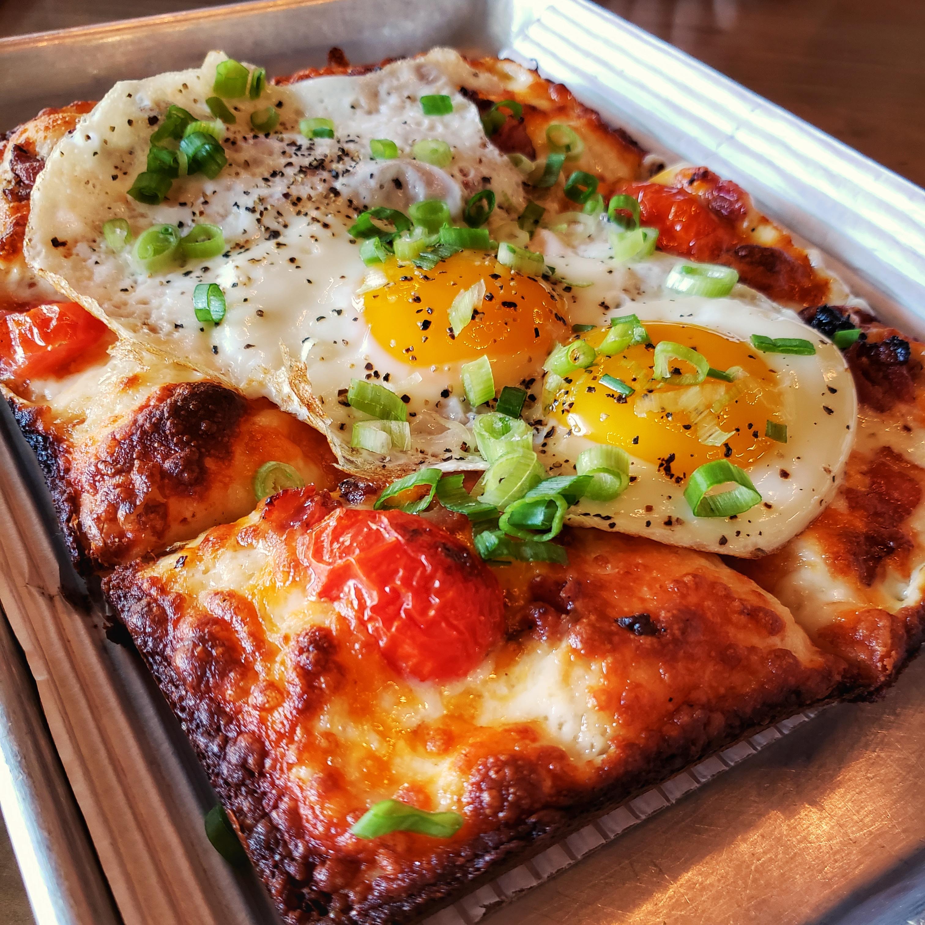 Brunch Pizza with sunny side up eggs on top
