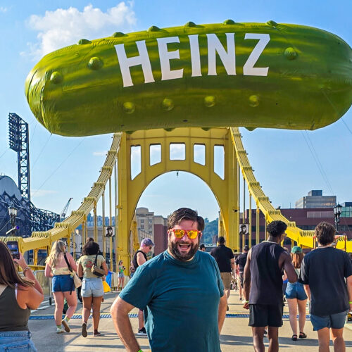 Alex at Picklesburgh 2025 under the pickle balloon on the bridge