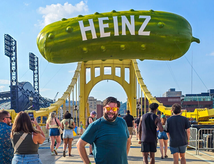 Alex at Picklesburgh 2025 under the pickle balloon on the bridge