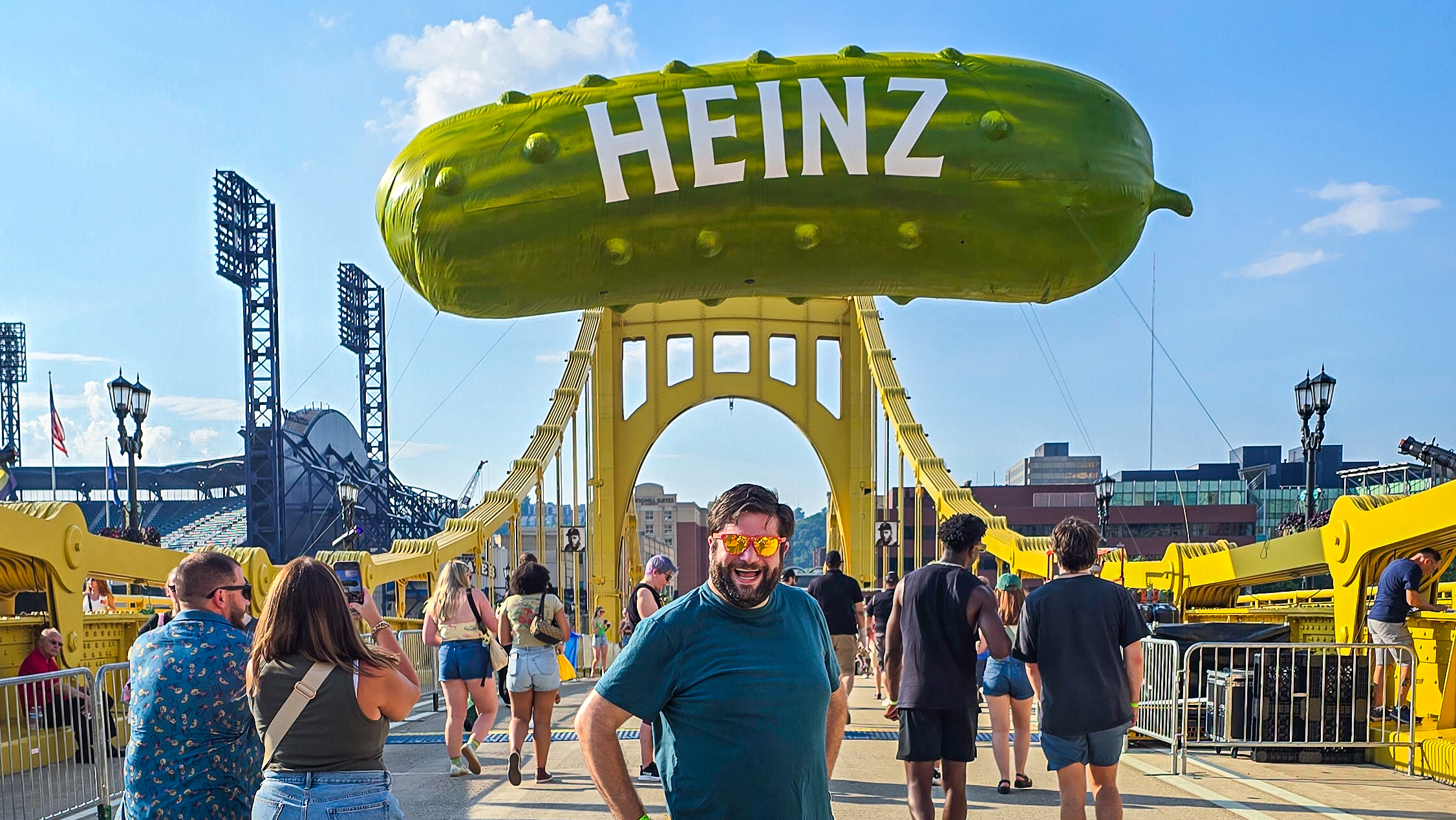 Alex at Picklesburgh 2025 under the pickle balloon on the bridge