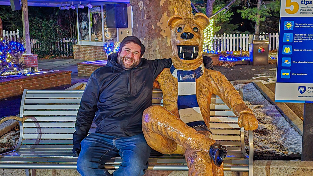Alex at Hersheypark with a Nittany Lion Statue