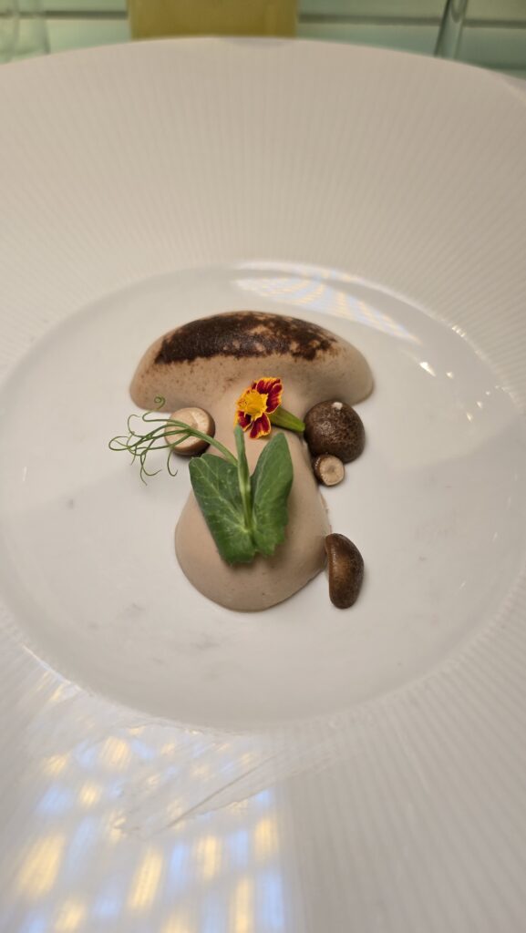 mushroom pate shaped into a mushroom served at Test Kitchen on Virgin Voyages Scarlet Lady cruise ship
