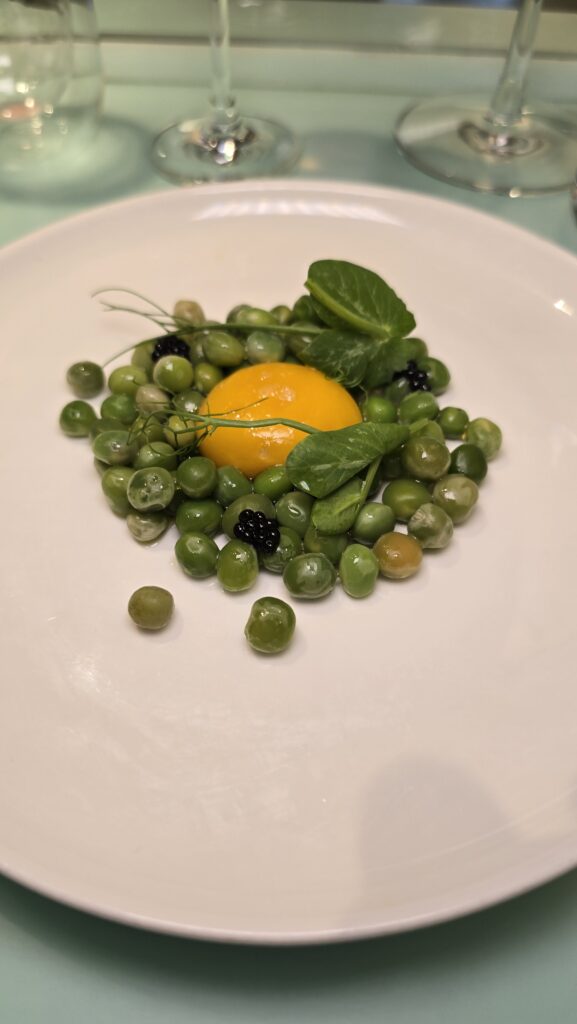 peas with egg yoke served at Test Kitchen on Virgin Voyages Scarlet Lady cruise ship