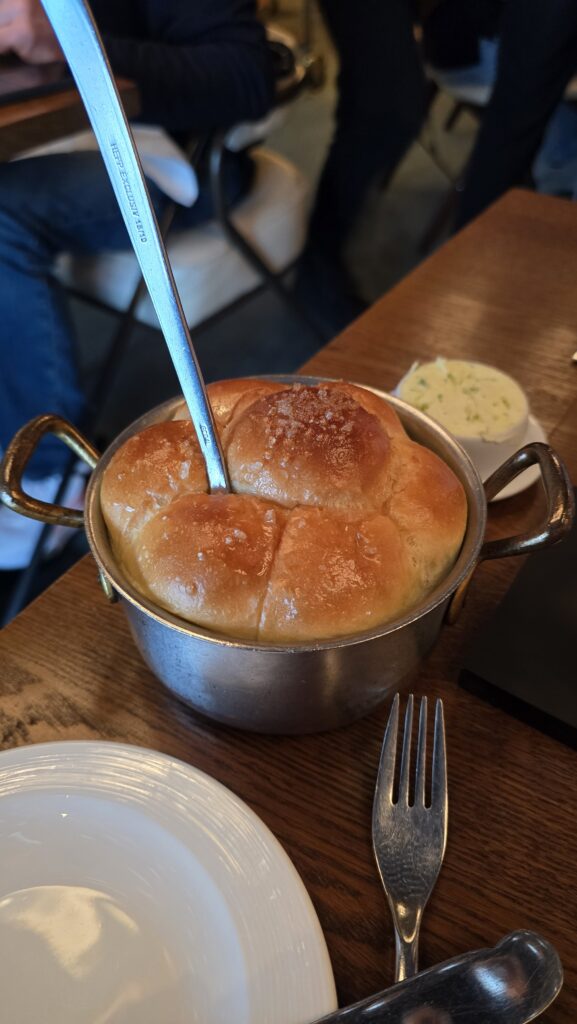 Dinner roles served at The Wake on Virgin Voyages Scarlet Lady cruise ship