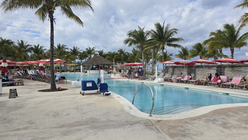 pool with beach umbrellas and pool lounge chairs at the Virgin Voyages Bimini Beach Club in the Bahamas