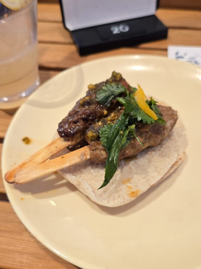 lamb kababs served at The Dock House on Virgin Voyages Scarlet Lady cruise ship