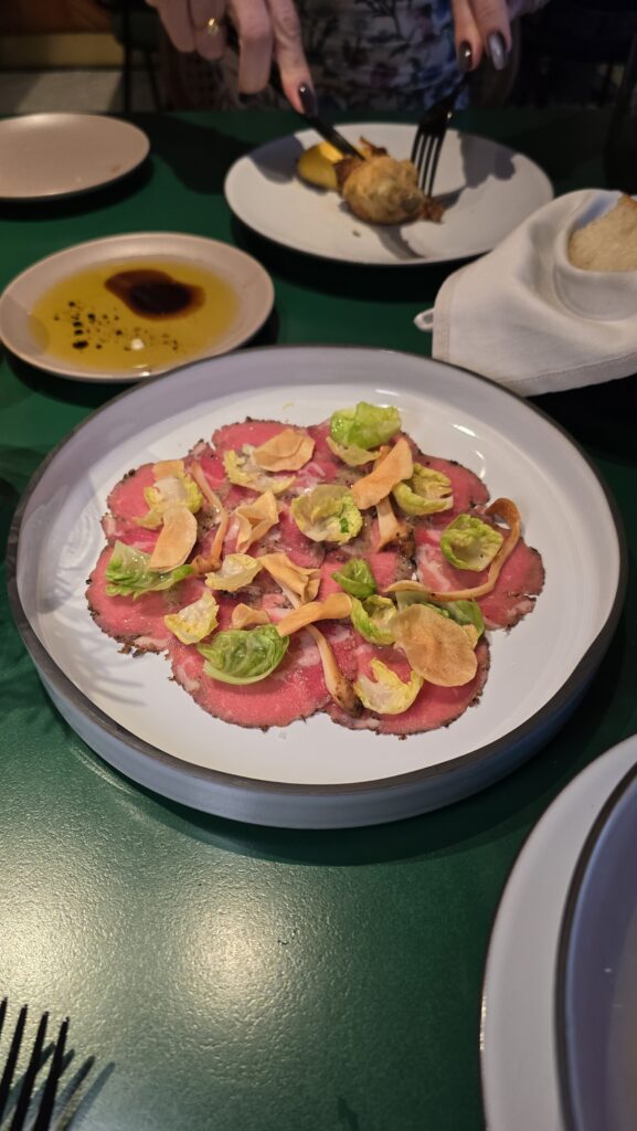 beef carpaccio served at Extra Virgin on Virgin Voyages Scarlet Lady cruise ship